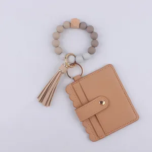 Llavero de pulsera con cuentas de silicona y cartera tarjetero de cuero PU con bonita borla
