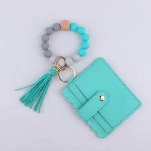 Llavero de pulsera de cuentas de silicona con tarjetero de cuero PU y borla para mujeres.