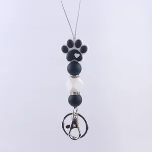 Close up detail view of silicone dog paw bead pendant charm keychain strap accessory