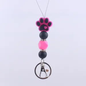 Cute silicone paw bead keychain with pink and black beads, metal ring hook accessory.