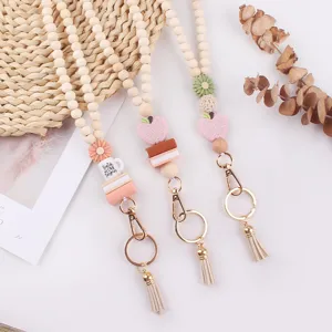 Wooden bead lanyard keychain featuring cute silicone flower and book charms, ideal for teachers.