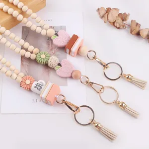 Wooden bead lanyard keychain with cute silicone apple book flower charms and tassels.