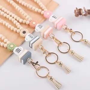 Houten kralen lanyard sleutelhanger met siliconen madeliefje boek koffiekopje bedels en kwastje.