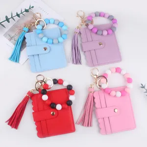Porte-cartes bracelet en perles de silicone avec gland en cuir et porte-clés pour femmes.