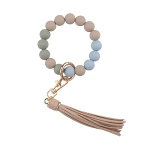 Silicone bead wristlet keychain detail featuring colorful round beads and chic leather tassel.