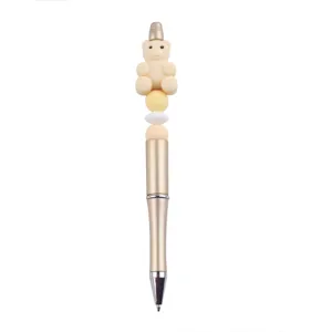 DIY beaded ballpoint pen with cute beige silicone bear topper and stylish gold metallic barrel.