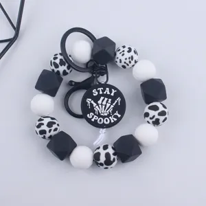 Black and white silicone bead wristlet keychain with Halloween spooky pendant keyring.