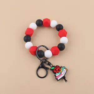 Pulsera llavero de cuentas de silicona con bonito colgante de libro de manzana de profesor.