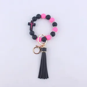 Silicone beaded wristlet keychain with cross charm, rhinestone spacers and black leather tassel.