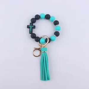 Silicone beaded keychain bracelet with cross charm and stylish leather tassel for women daily use.