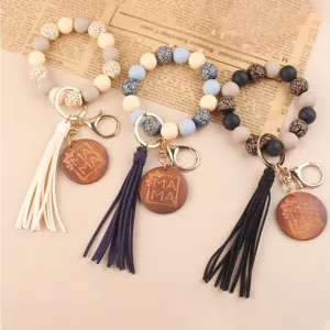 Beaded wristlet keychain with PU leather tassel and wooden MAMA pendant, stylish and convenient.