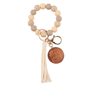 Silicone bead wristlet keychain with PU leather tassel and engraved MAMA wooden charm pendant for mothers.