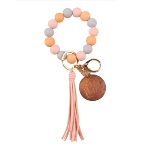 Silicone bead wristlet keychain with wooden MAMA charm and cute tassel detail for women.