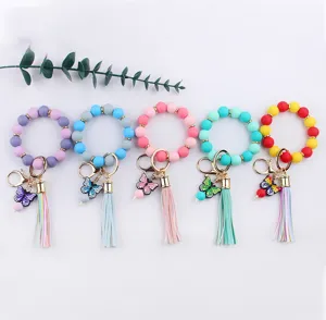 Colorful silicone bead wristlet keychain with butterfly charm and PU leather tassel.