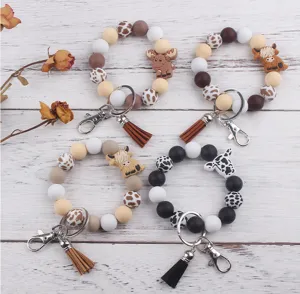 Pulsera llavero de cuentas de silicona con dijes de animales de dibujos animados y borla.