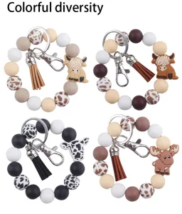Llavero de pulsera de cuentas de silicona lindo diseño de vaca de dibujos animados borla