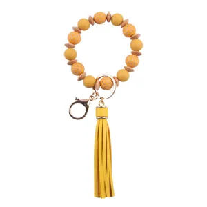 Llavero de pulsera de cuentas amarillas con borla de cuero PU silicona y cuentas de madera