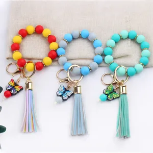 Silicone beaded wristlet keychain with PU leather tassel and cute butterfly charm for women.