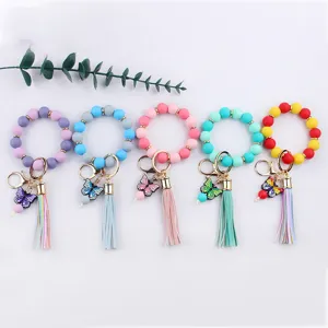 Colorful silicone bead wristlet keychain with cute cartoon butterfly charms and PU leather tassel.