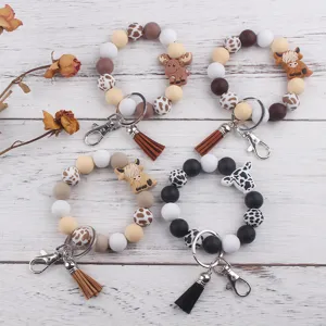 Llavero de pulsera de cuentas de silicona con dijes de animales y borla de cuero PU