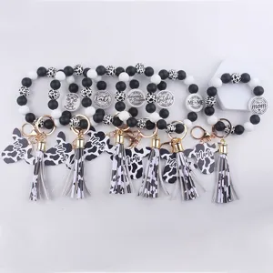 Cow print silicone bead keychain with tassel and cow head pendant, trendy wristlet strap.