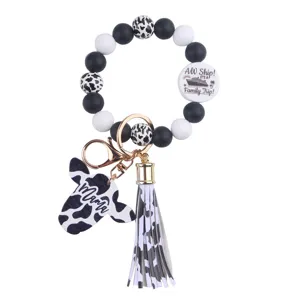 Silicone bead wristlet keychain with cow print, tassel and cute charms for women and girls daily use.