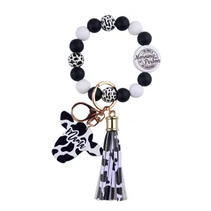 Silicone bead bracelet keychain with cow pattern tassel and cute pendant for women daily use.