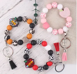 Silicone beaded wrist keychain with teacher apple charm and cute PU leather tassel accessories.