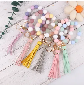 Colorful silicone bead wristlet keychain with leather tassel, stylish and practical accessory.