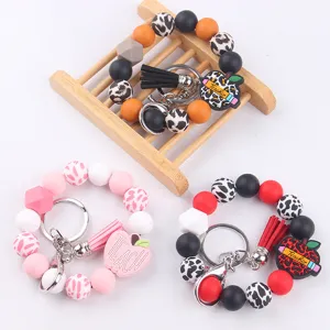 Silicone beaded wrist keychain with teacher apple pendant and tassel for women stylish gift.