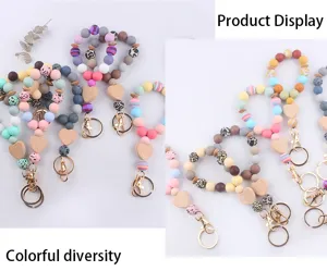 Silicone beaded wristlet keychain with wooden heart charm and metal clasp details.