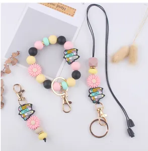 Colorful silicone beaded keychain set with wristlet strap and cute book flower charms.