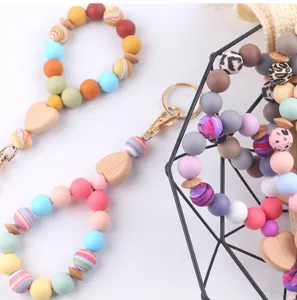 Silicone wristlet keychain with wooden heart and colorful beads, detail view for women accessories.