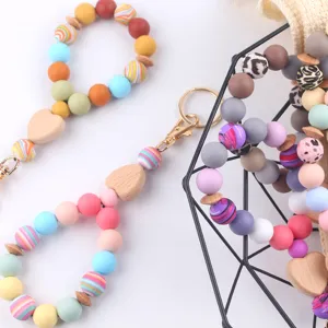 Colorful silicone beaded wristlet keychain with wooden heart charm and metal ring for women.