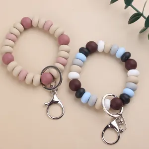 Silicone bead keychain detail closeup showing smooth texture, colorful beads and sturdy metal clasp.