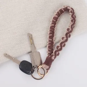Handmade braided wrist strap keychain brown beige woven lanyard key ring accessory.