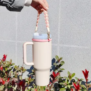 Handcrafted woven cup strap with pink large tumbler outdoor detail view stylish portable accessory.