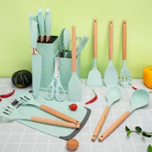 Mint green silicone kitchen utensil set with wooden handles on a checkered background