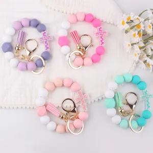 Silicone beaded wristlet keychain with tassel and cross pendant, cute fashion keychain for women.