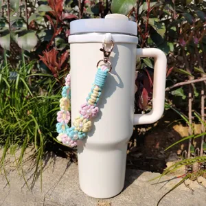 Handcrafted crochet daisy pearl tumbler strap, cute aesthetic water bottle accessory.