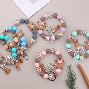 Silicone bead wristlet keychain with cute cartoon cow pendant, tassel and heart ring.
