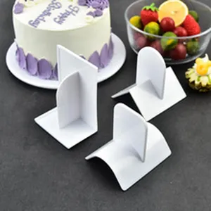 Three white plastic cake scrapers for cream smoothing and edge finishing