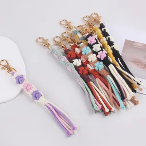 Handmade woven flower keychain lanyard, stylish cotton rope bag charm accessory with gold clasp.