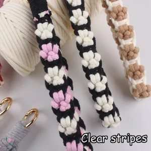Close up detail of handmade cotton rope keychain showing clear striped flower pattern.