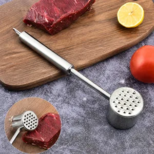 Close-up of professional stainless steel meat tenderizer hammer on a wooden cutting board
