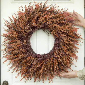 Autumn artificial eucalyptus wreath detail, front door hanging decor, seasonal home ornament.
