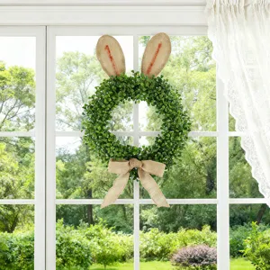 Couronne de buis de Pâques avec oreilles de lapin en toile de jute pour décoration murale.