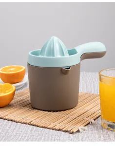 Close-up detail shot of the portable manual citrus juicer showing its handle and cone design.