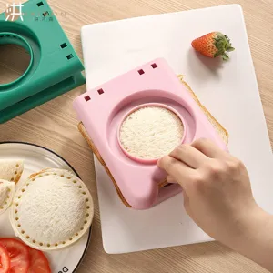 Handheld plastic sandwich cutter and sealer mold for making round toast bread and breakfast easily.