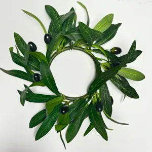 Artificial olive leaf wreath detail, green leaves and black olives, candle ring decor.